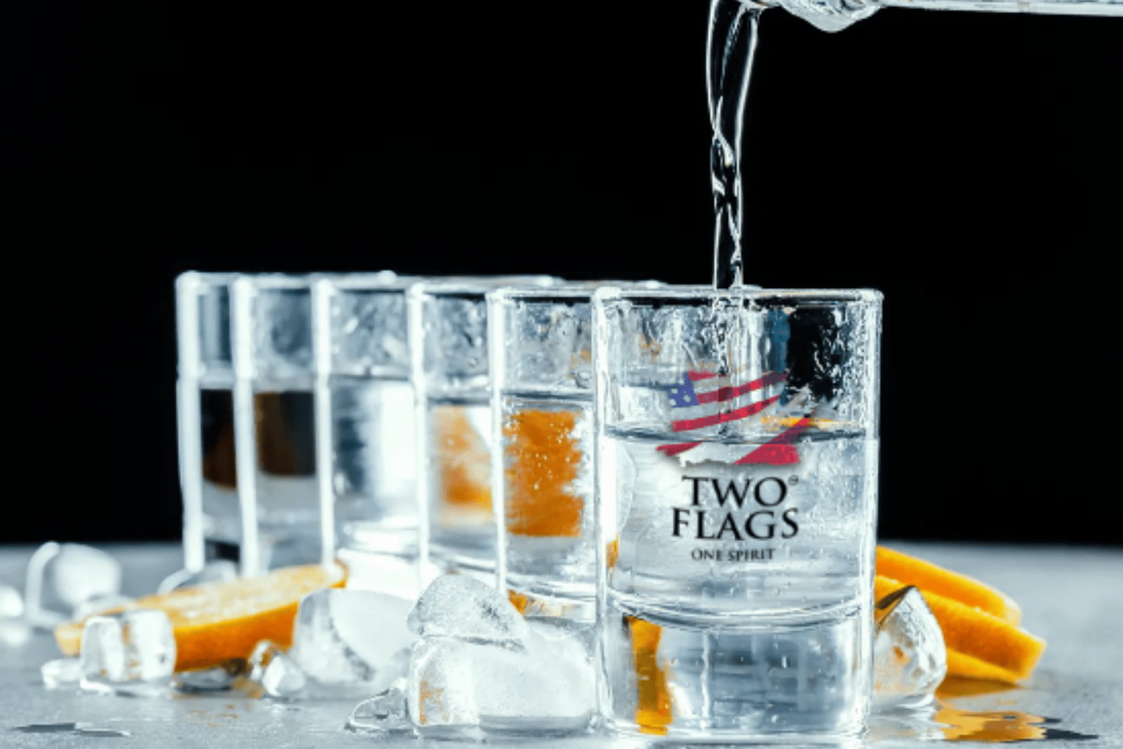 Two Flags shot glasses with Two Flags Vodka being poured into one